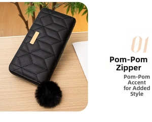 Detail of black long wallet with geometric quilting, golden trim, and fuzzy pom-pom charm