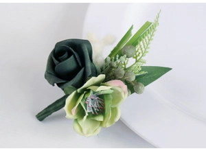 Close-up of handmade dark green silk rose boutonniere with realistic forest style details