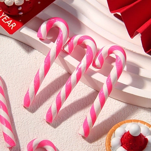 Detailed view of pink and white striped polymer clay candy cane miniatures for DIY crafts