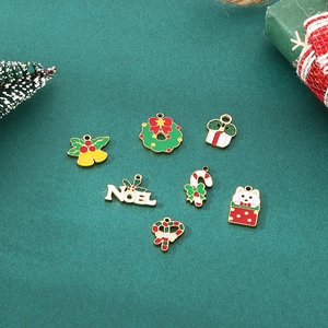 Set of 7 colorful Christmas enamel charms including snowman, bells and Noel on green background