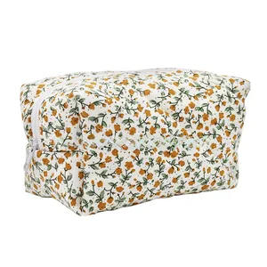 Detail of floral canvas toiletry bag with yellow flowers and white zipper closure