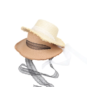French retro straw sun hat with lace ribbons and frayed edges in beige and caramel