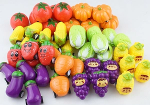 Top view of mini pull-back toy cars shaped like realistic fruits and colorful vegetables