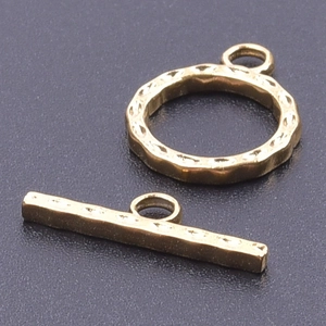 Detailed macro view of 18k gold plated hammered texture toggle clasp for DIY jewelry