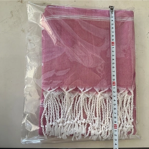 Detail of pink and white striped Turkish towel showing fringe and 35cm size measurement