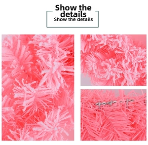 Close-up of pink Christmas wreath with white flocked snow texture and PVC needles