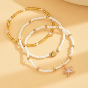 Three-piece bohemian beaded anklet set with starfish and shell charms in gold and white