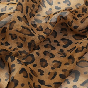 Detailed close-up of leopard print chiffon fabric with soft translucent texture