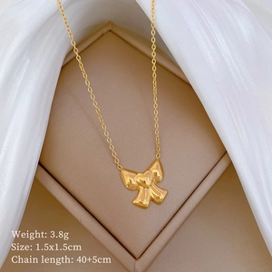 Macro shot of gold bow pendant showing 3.8g weight and 1.5x1.5cm size details