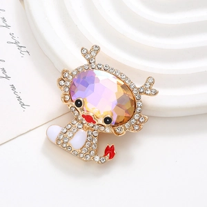 Detailed macro of a gold dragon brooch with multi-colored rhinestones on a textured base