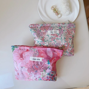 Detailed macro view of colorful floral liberty print canvas cosmetic bags with metal zippers