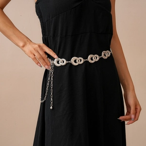 Silver geometric interlocking ring waist chain displayed on a black dress waist