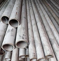 Close-up of stacked industrial stainless steel pipes with natural metallic finish