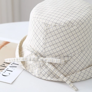 Japanese style checkered bucket hat with wide brim and bow tie detail in beige and yellow