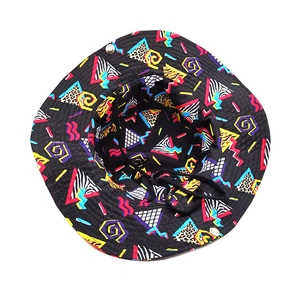 Detail view of Memphis-style geometric prints and vent eyelets on this bucket hat