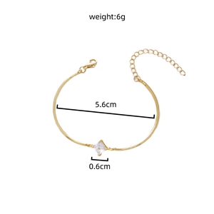 Detail of adjustable gold bracelet featuring a square zircon and size measurements