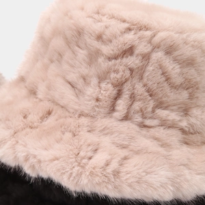 Macro detail of plush faux mink fur texture on a warm winter bucket hat in soft pink