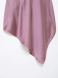 Detail of mauve satin fabric showing the smooth texture and asymmetrical hemline