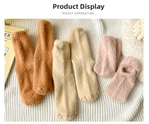 Close-up of thick plush mink velvet socks in brown, beige and pink for winter warmth