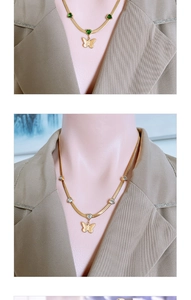 Detail of gold snake chains with green and white heart gems and butterfly pendants