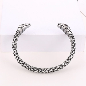 Detailed view of silver double snake head cuff bracelet with intricate scale texture