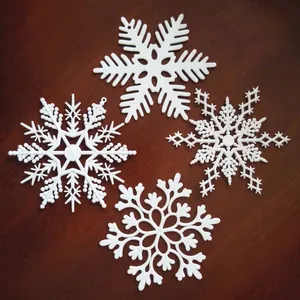 Set of four 10cm white plastic snowflake ornaments for Christmas holiday decorations
