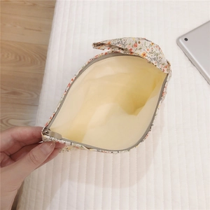 Detailed internal view of small floral cotton storage pouch with smooth zipper