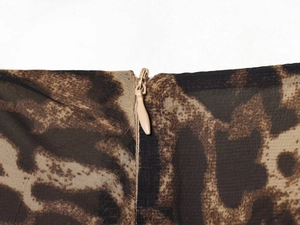 Detail of invisible zipper closure on leopard print short dress with pleated waist