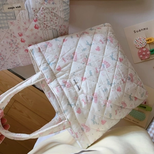 Detailed view of quilted cotton handbag with floral patterns and 'simple wish' label