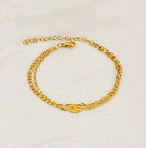 Detail of 18K gold-plated stainless steel layered bracelet with Hamsa Hand pendant charm