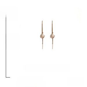Detailed view of 10cm gold plated drop earrings with cat eye stones and alloy texture