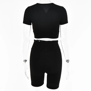 Rear view of black ribbed knit two-piece set with cropped top and high-waist shorts