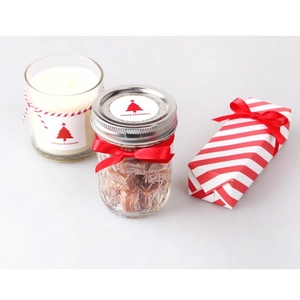 Christmas gift box set with white candle, glass candy jar and festive red ribbon