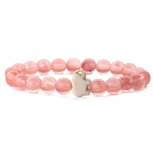 Detailed view of pink quartz beads bracelet with a white elephant charm and elastic band