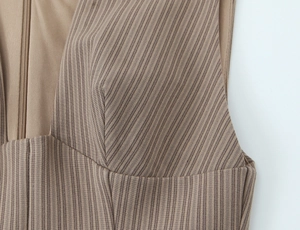 Detail of brown striped dress fabric with high-quality invisible zipper and seam stitching
