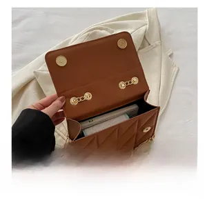 Brown quilted crossbody bag with gold chain showing internal storage capacity and layout