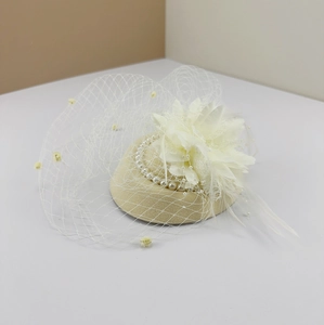 Beige fascinator hat with white mesh veil, faux pearls and feathers for vintage parties