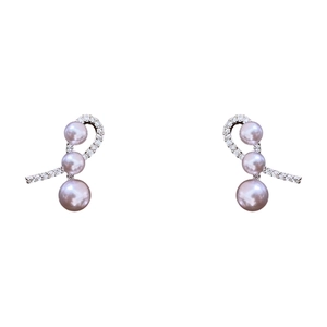 Silver bow stud earrings featuring sparkling cubic zirconia and light purple pearls