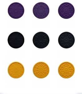 Macro view of heat-resistant silicone coasters with embossed floral patterns in multiple colors