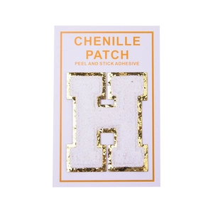 Detailed close-up of white chenille letter H patch with sparkling gold sequin border trim