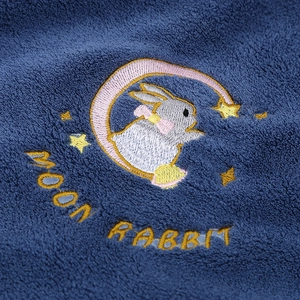 Detailed embroidery of Moon Rabbit on thick navy blue coral fleece bath towel fabric