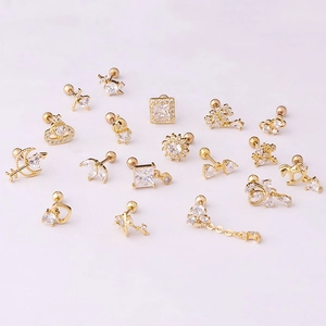 Golden stainless steel stud earrings set with zircon stars and moons on pink background