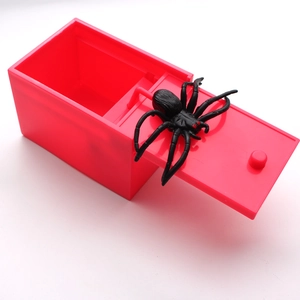Scary prank box detail showing the black spider jumping out of the red plastic container