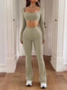 Detail of sage green yoga set with long sleeve crop top and high waist flared trousers