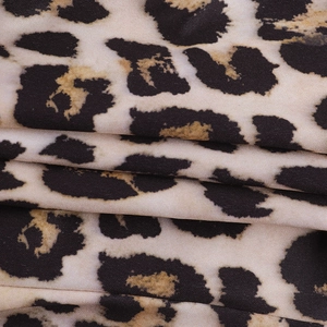 Close-up of soft leopard print fabric showing detailed textile texture and draping
