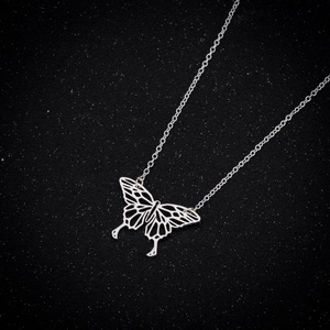 Exquisite hollow butterfly pendant necklace in silver stainless steel on black glitter background