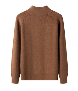 Detail of brown knit texture and ribbed cuffs on a men's quarter-zip sweater