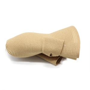Close-up of foldable beige straw hat showing fine woven texture and portable design