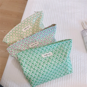 Detail of floral cotton makeup bags with simple wish labels and zipper closures