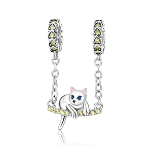 Detailed cat charm bead in silver with yellow and blue gemstones on a white background